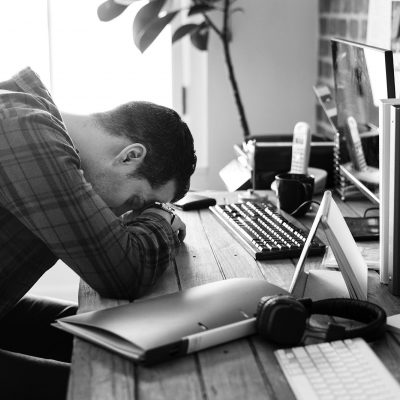 Tired man napping on the working desk