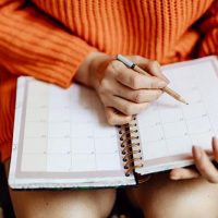 Woman writing on her daily planner